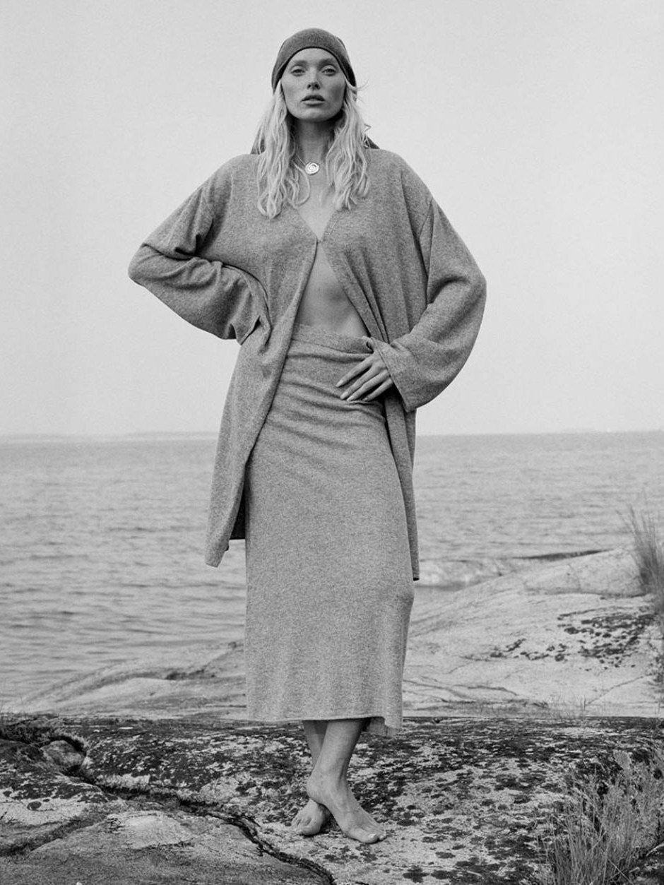 Elsa Hosk in a long gray knit look on a rocky beach