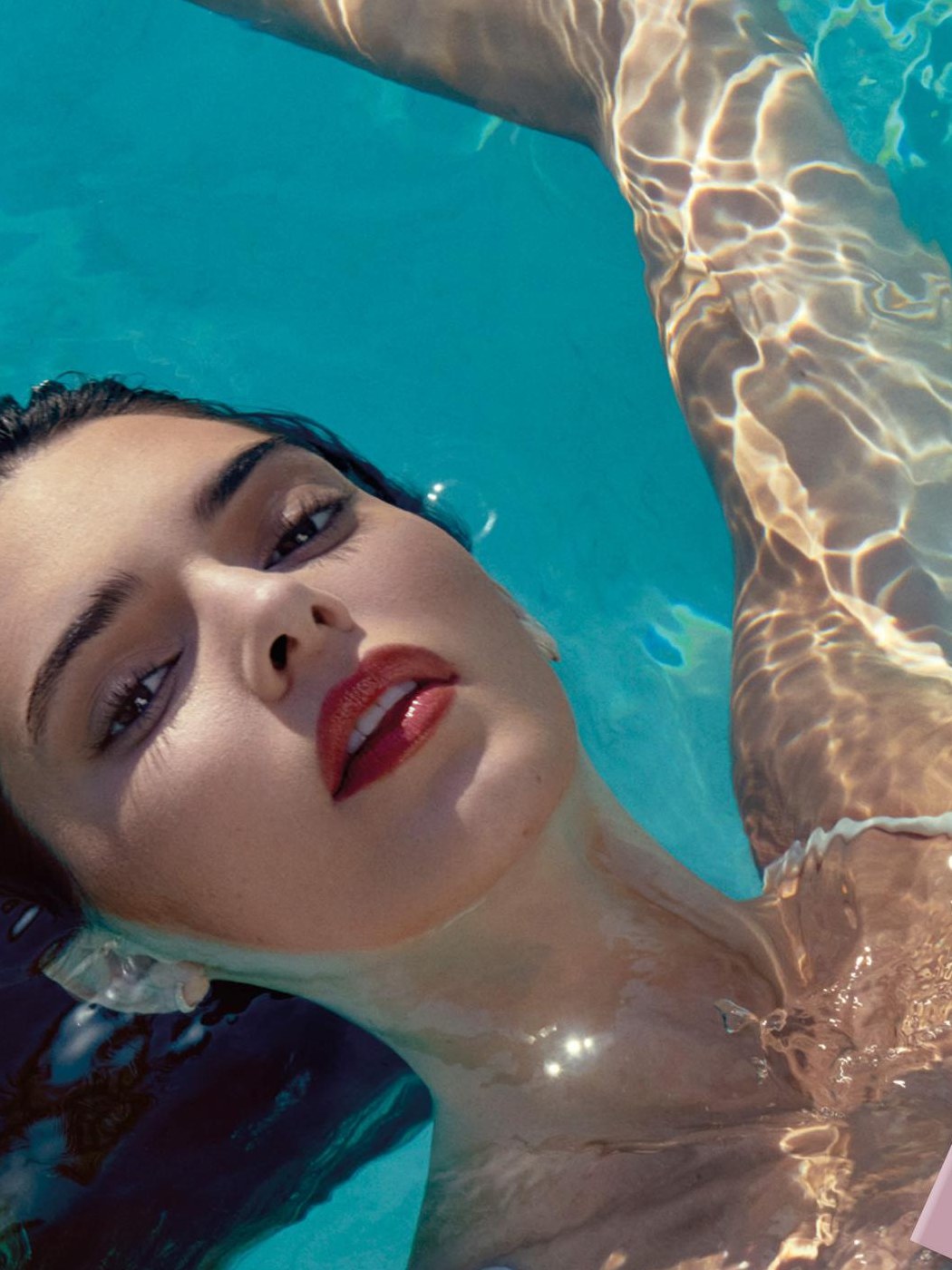 Kendall Jenner floating in turquoise water in the BY FAR Daydream campaign