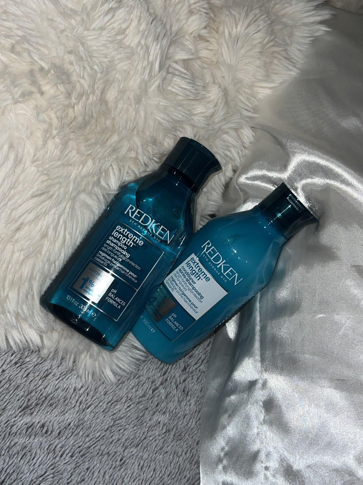 Two Redken All Soft shampoo and conditioner bottles side by side