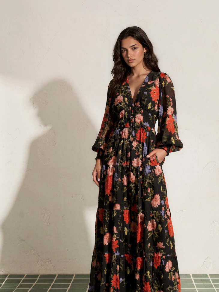 Model in a dark floral maxi dress against an ivory studio wall