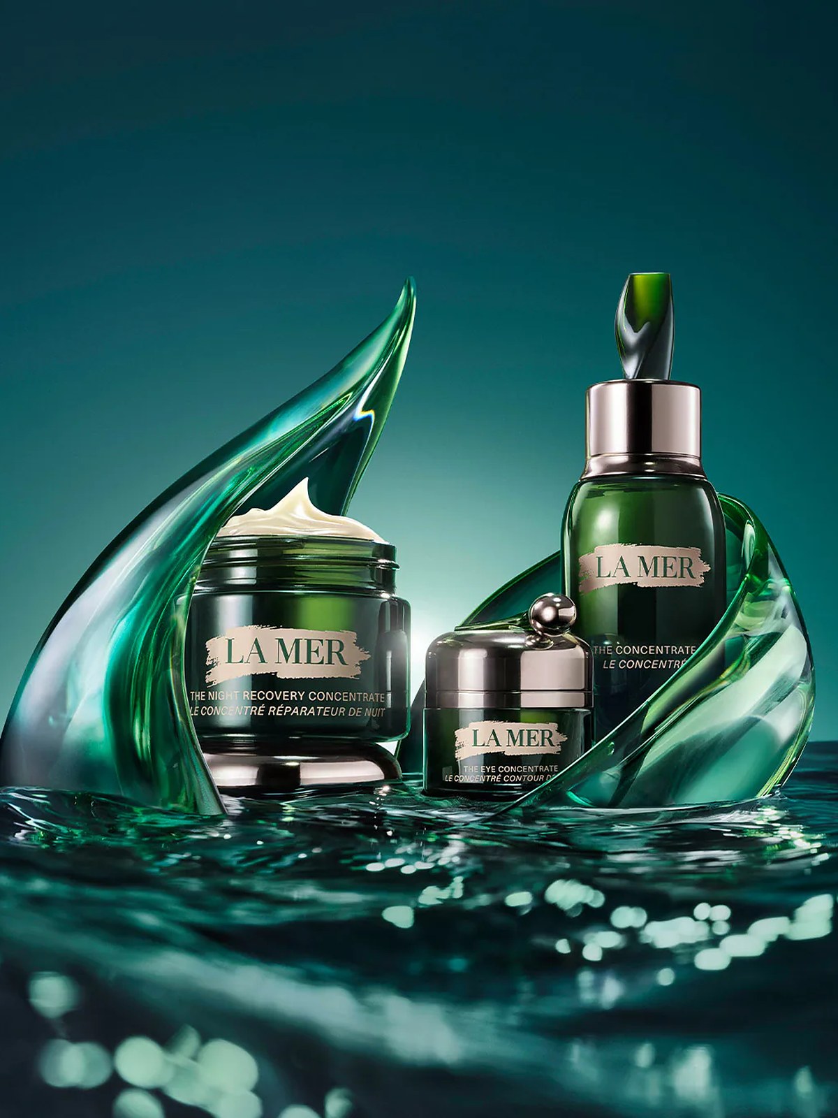 La Mer Concentrate jars and serum among green glass waves on water