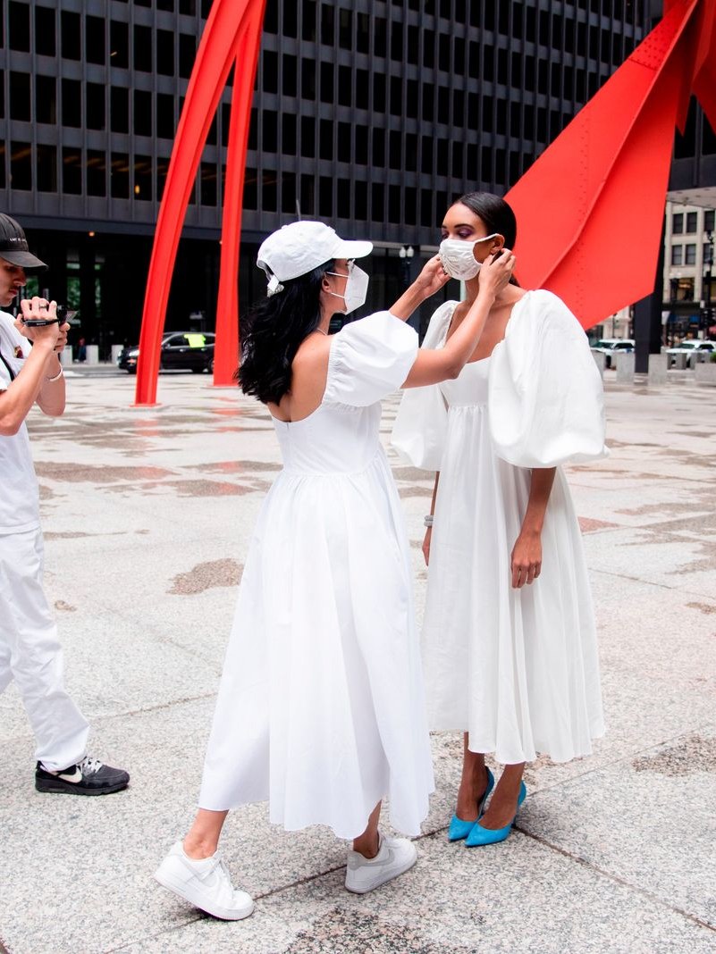 Azeeza Khan with a model in white looks at Chicago’s Federal Plaza
