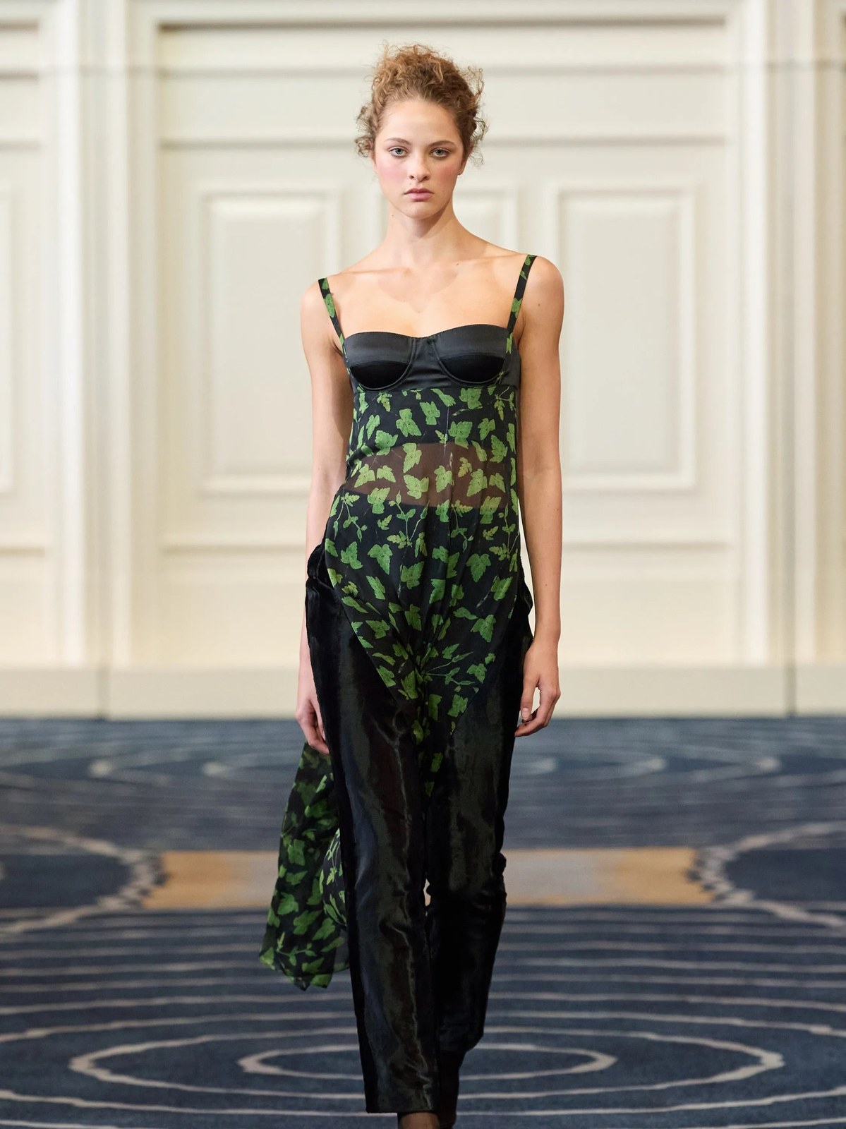 Model in a black and green printed gown on the Alejandra Alonso Rojas runway