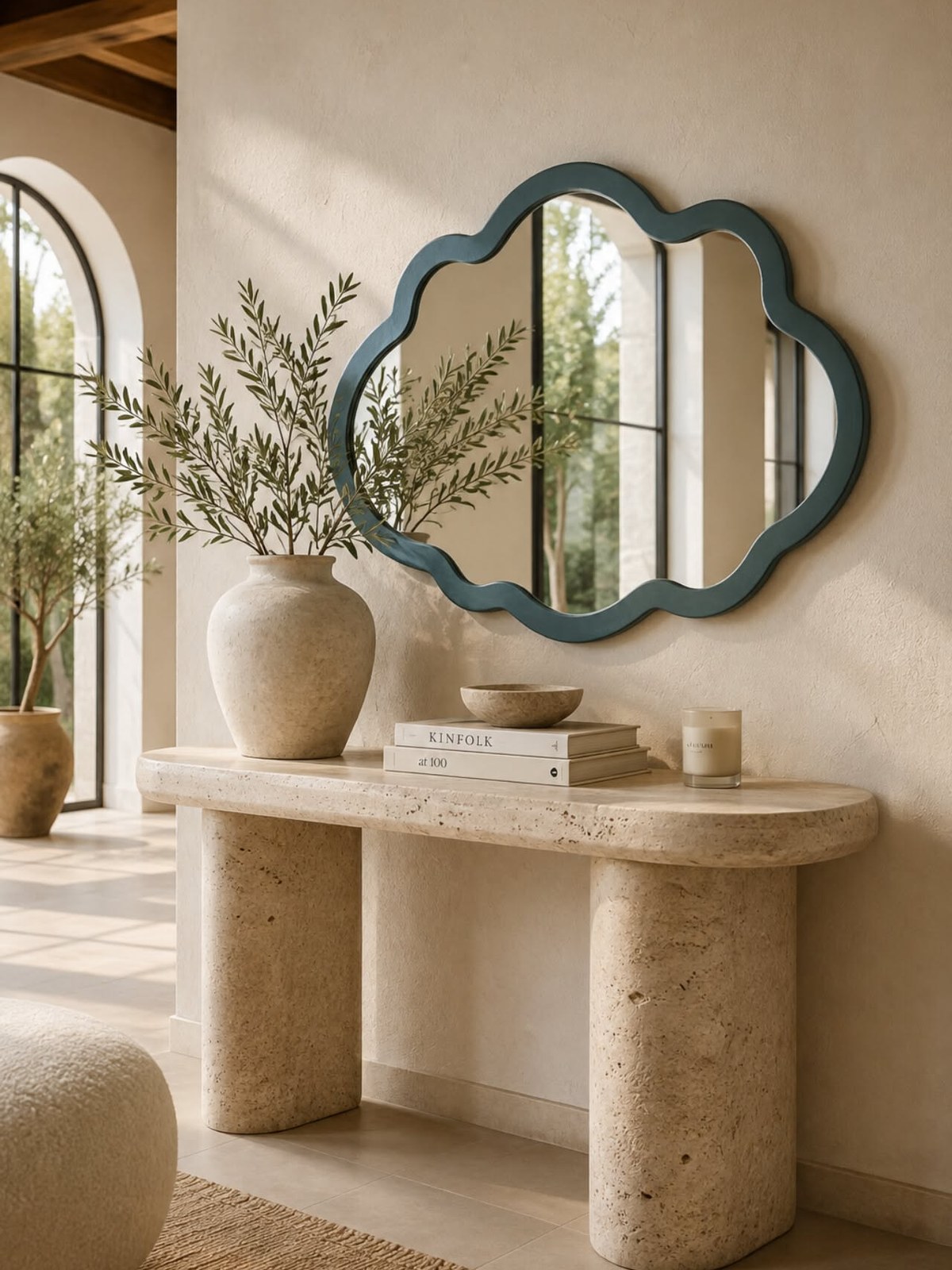 Cloud-shaped green framed mirror above a stone console