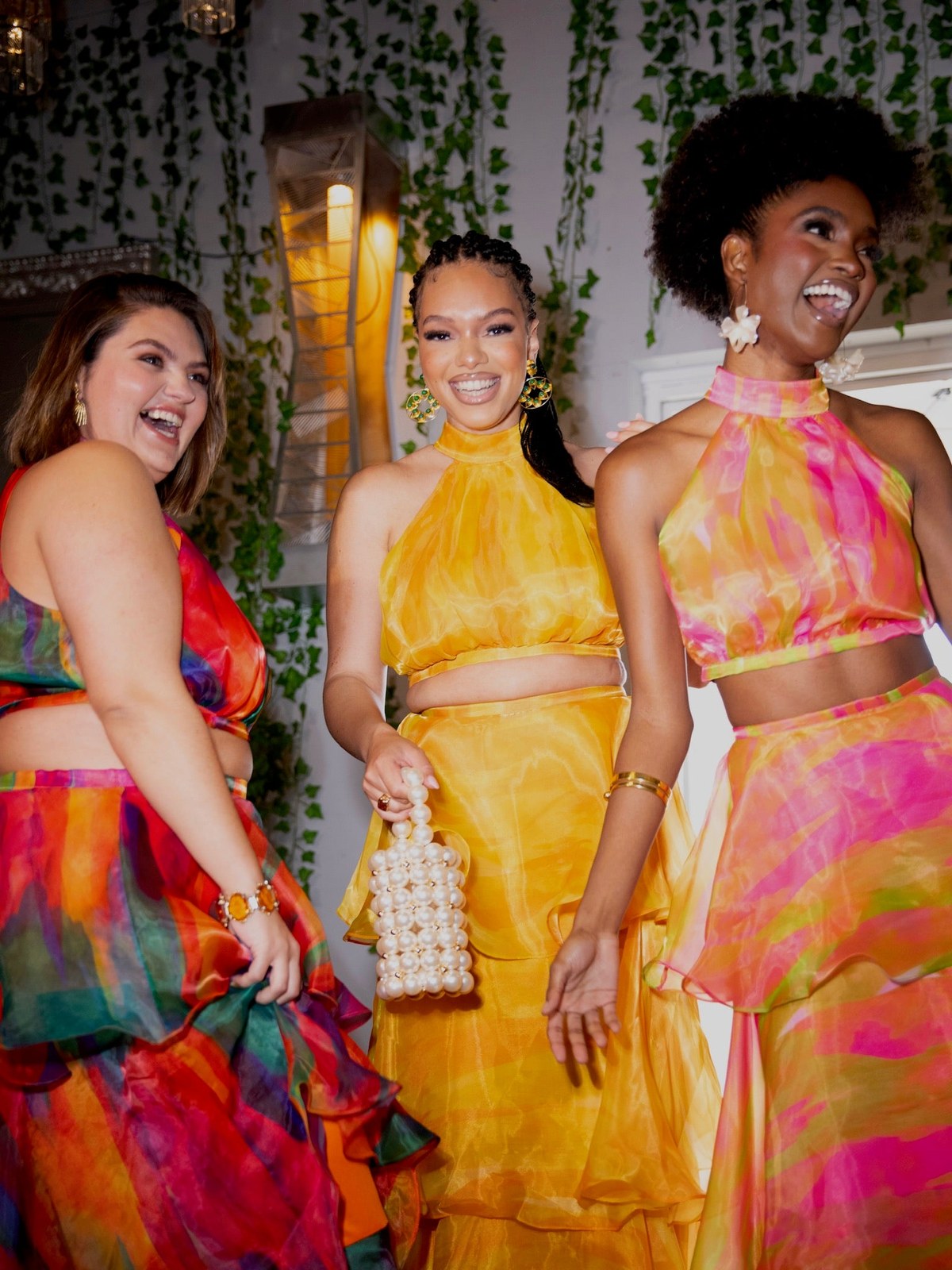 Group of women in colorful printed dresses at an evening gathering