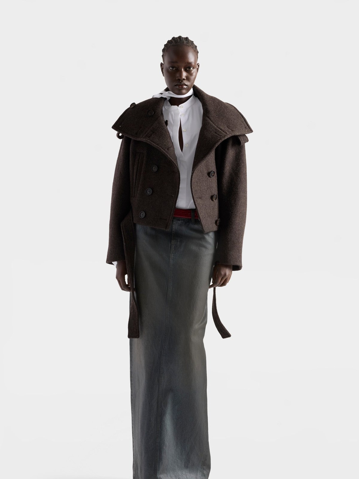Model in a chestnut wool short coat over a long denim skirt
