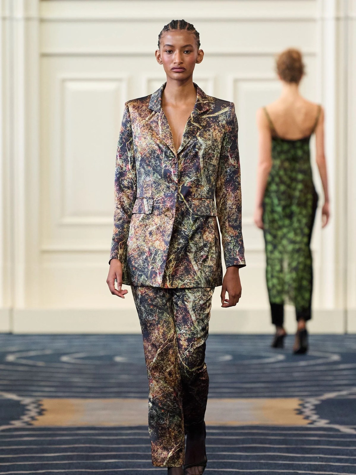 Model in a floral tailored suit on the Alejandra Alonso Rojas runway