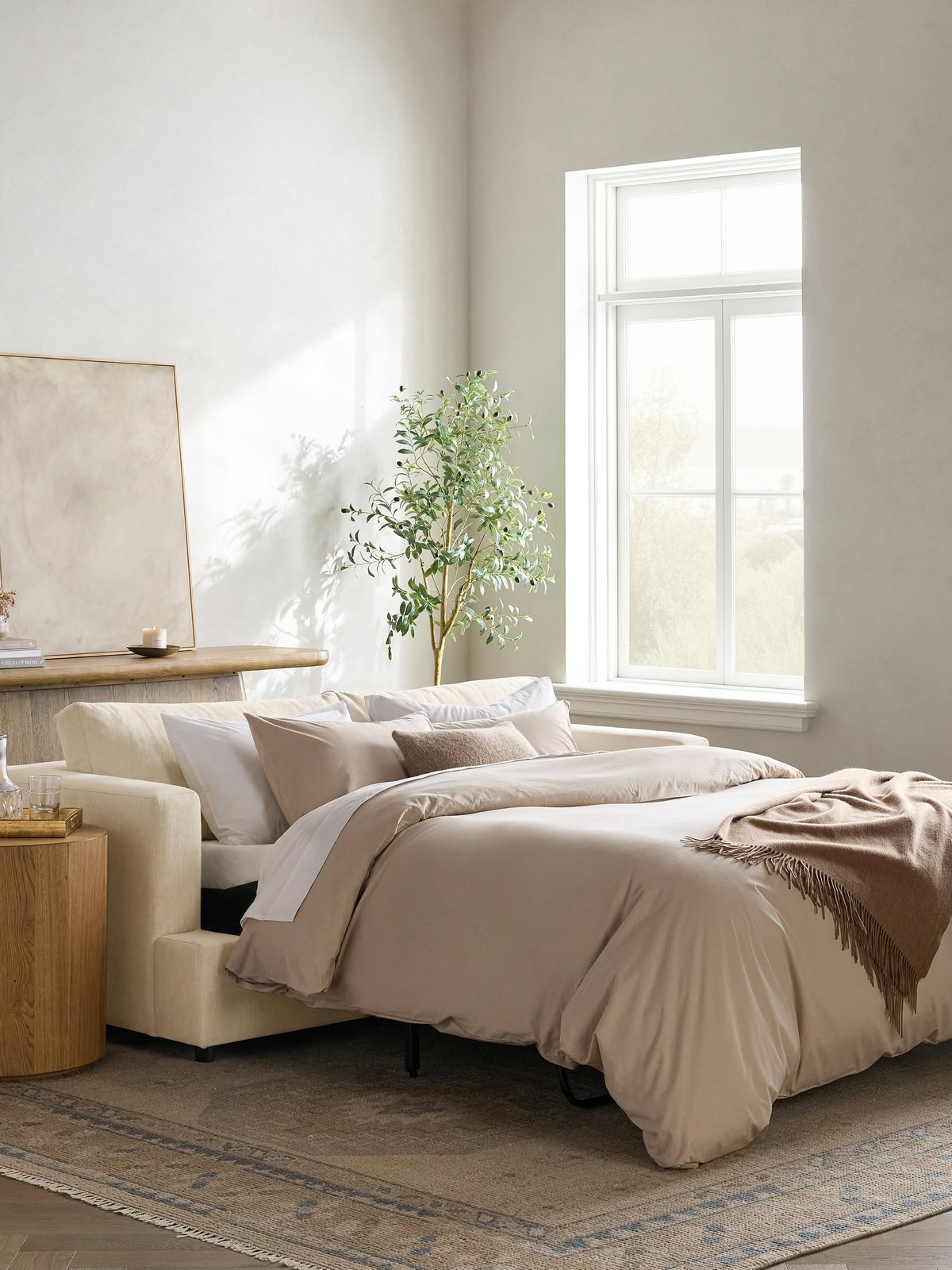 Sofa bed opened with white bedding in a bright room