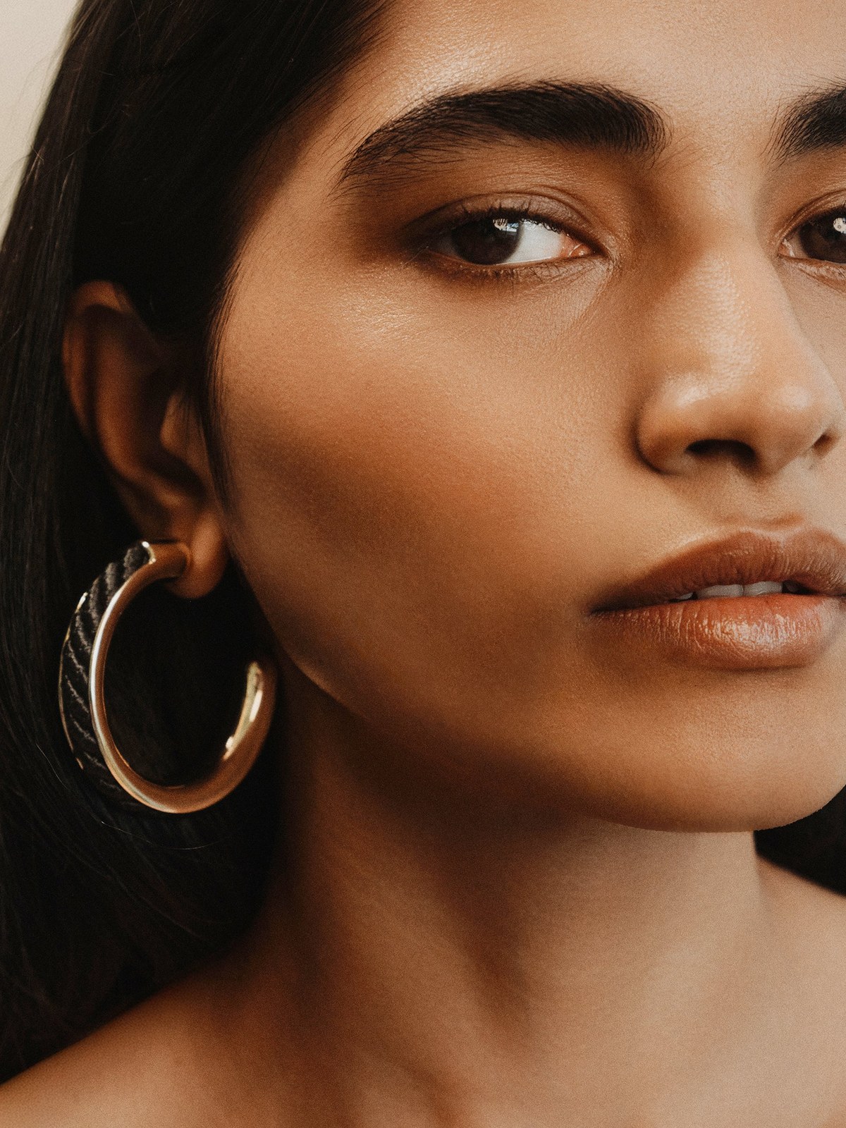 Close portrait showing a model's large hoop earring