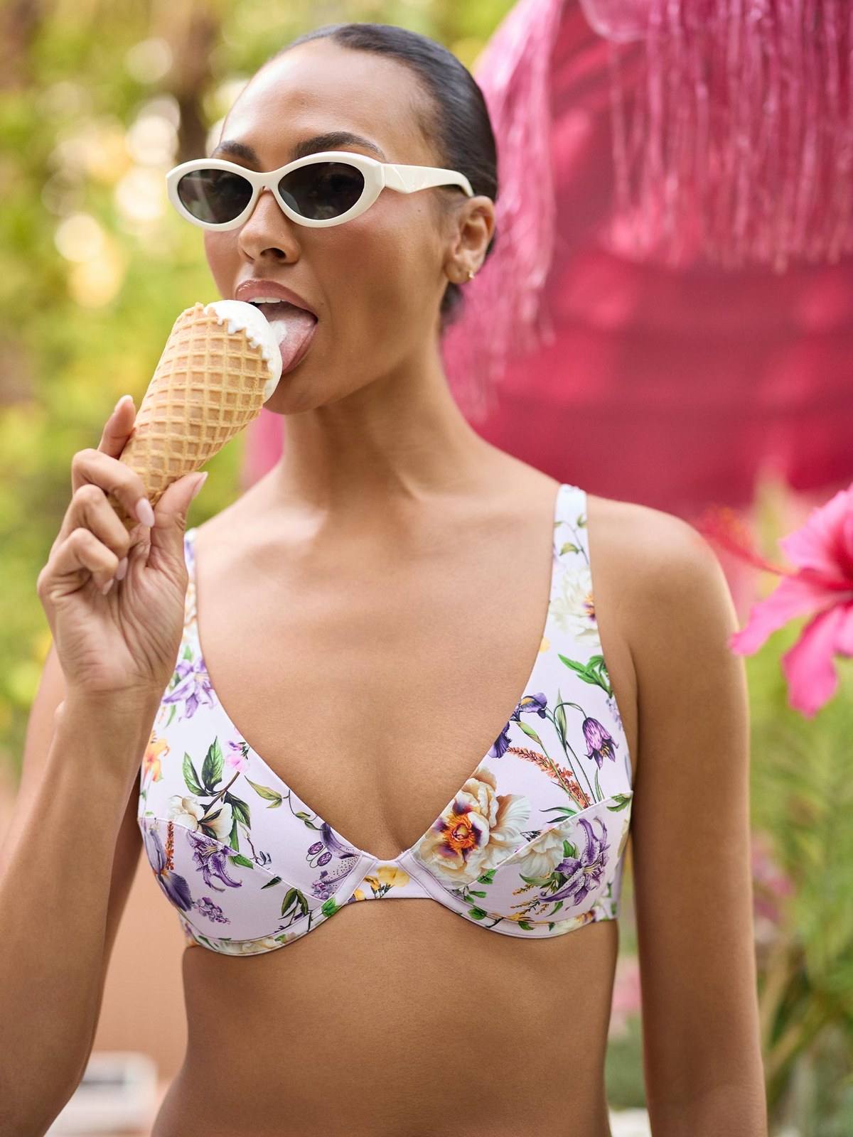 Model in a floral underwire bikini top eating ice cream outdoors
