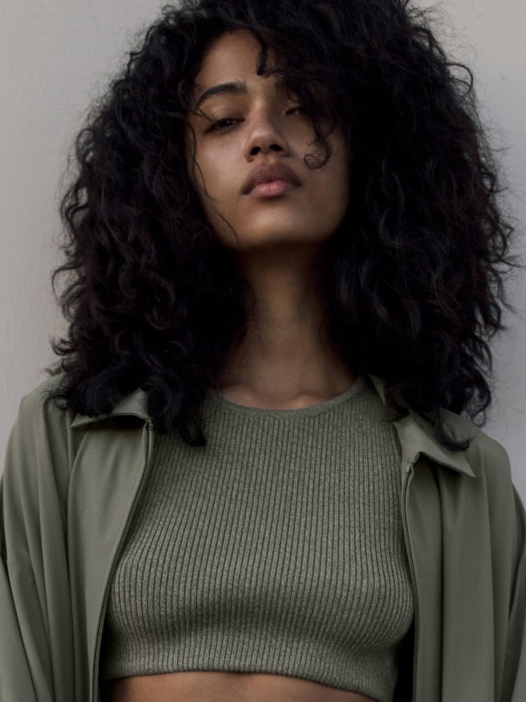Woman in a ribbed top and open jacket in the ESSENTIALS campaign