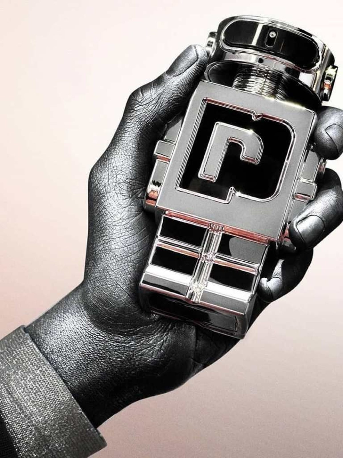 Hand painted in silver and black holding the chrome Phantom robot bottle against a soft pink background