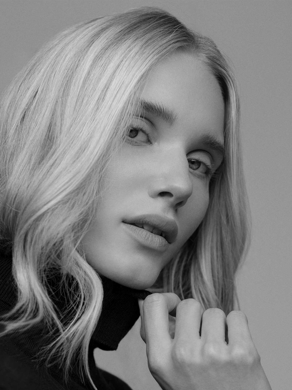 Blonde model with softly waved hair in a close beauty portrait