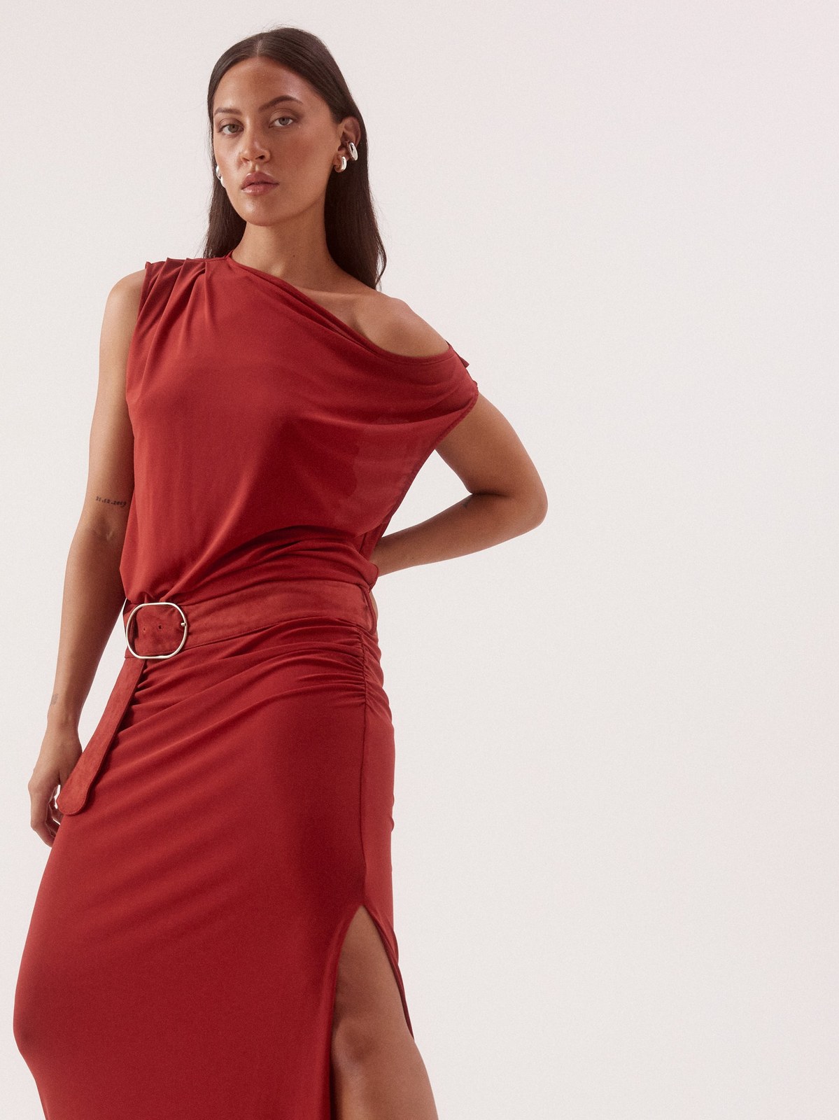 Model standing in a red one-shoulder SOVERE dress