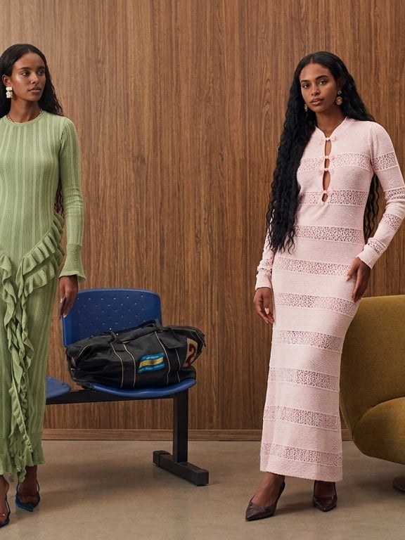 Two models in pastel Capittana dresses in a wood-paneled lounge
