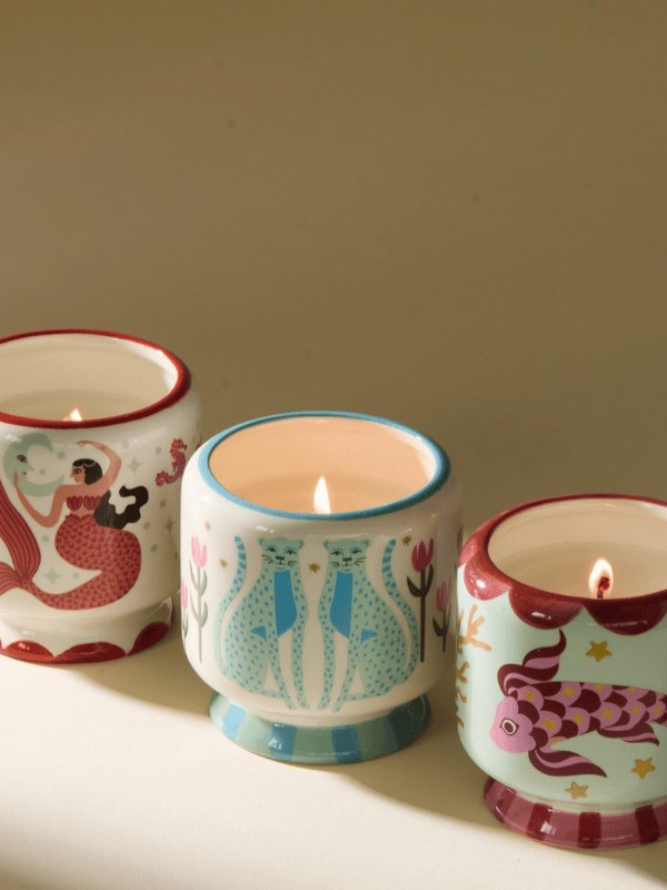 Illustrated ceramic candles in warm afternoon light