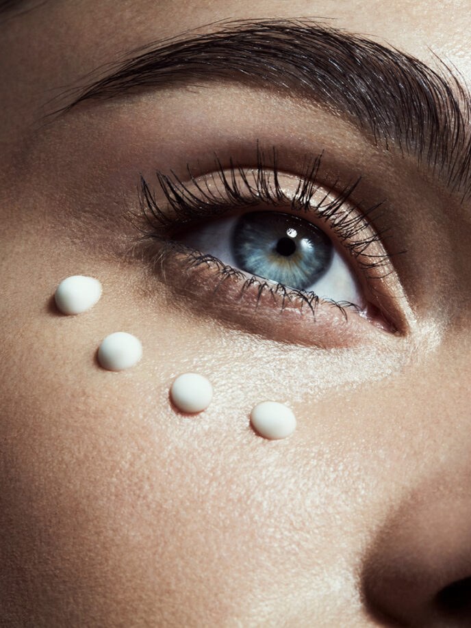 Model with small skincare drops along the cheek in a MZ SKIN campaign