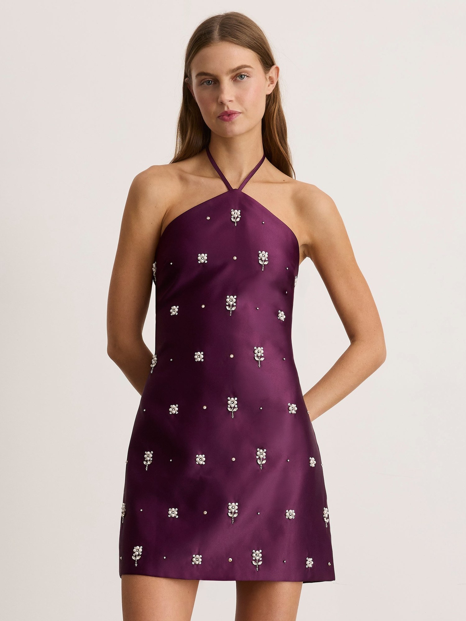 Model in a plum embellished halter mini dress