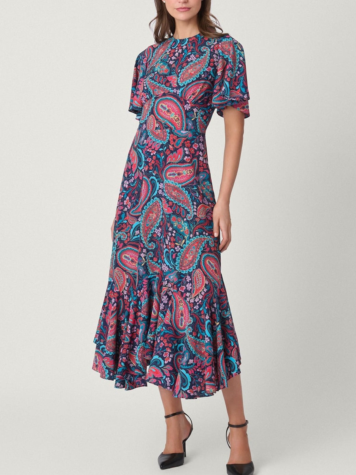 Model in a paisley flutter sleeve midi dress with black pumps