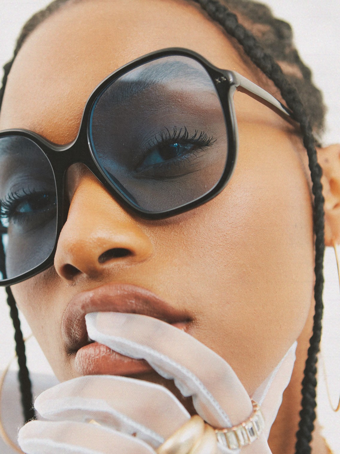 Close-up of a model wearing oversized dark Lexxola frames
