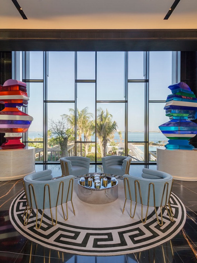 Hotel lounge with sculptural colorful shelving and a circular patterned rug