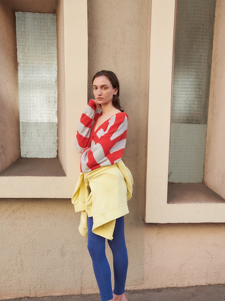 Woman in a red striped knit and yellow layer
