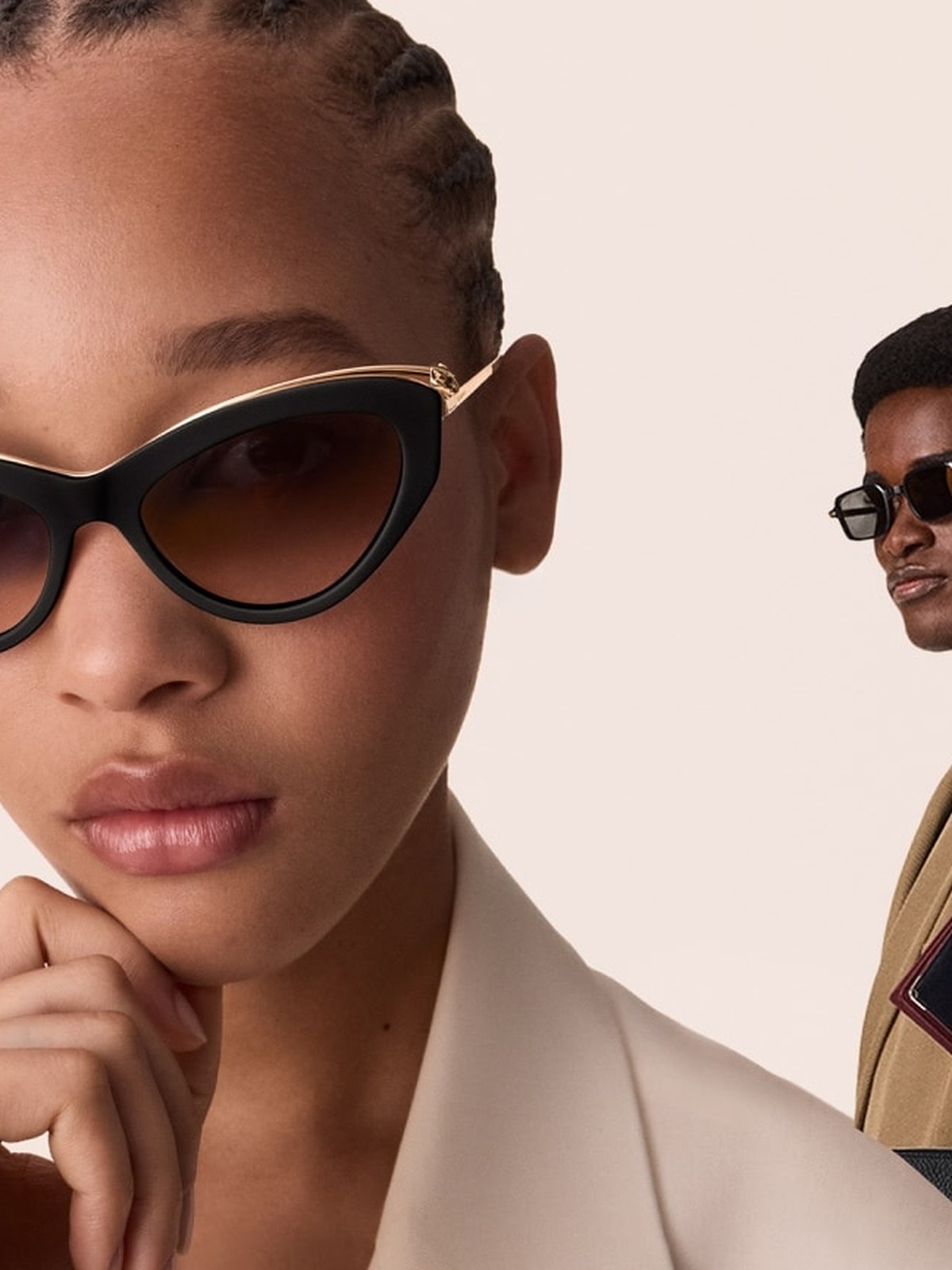 Two models in cat eye sunglasses and a cream blazer
