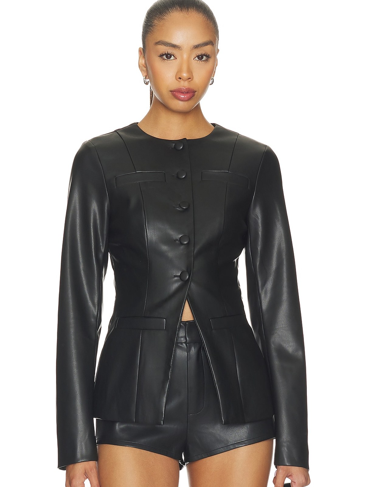 Model in a black faux leather collarless blazer and matching shorts