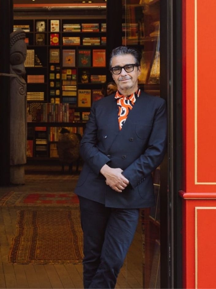 An author stands at the entrance to an Assouline boutique.