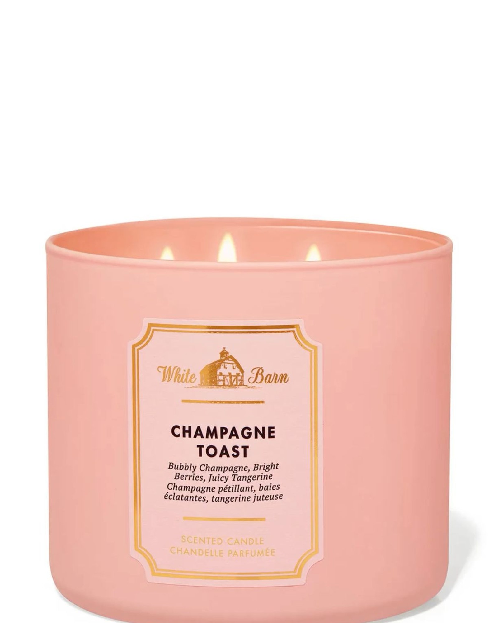 Pink Champagne Toast three-wick candle with a gold-framed White Barn label, flames lit