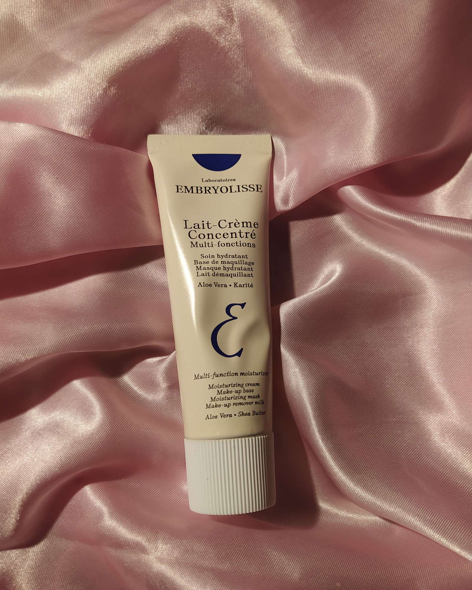 Tube of Embryolisse Lait-Crème Concentré lying on pink satin