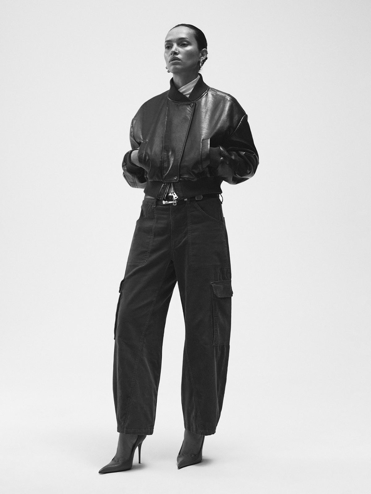 Black and white photo of a woman in a black Citizens of Humanity jacket and trousers