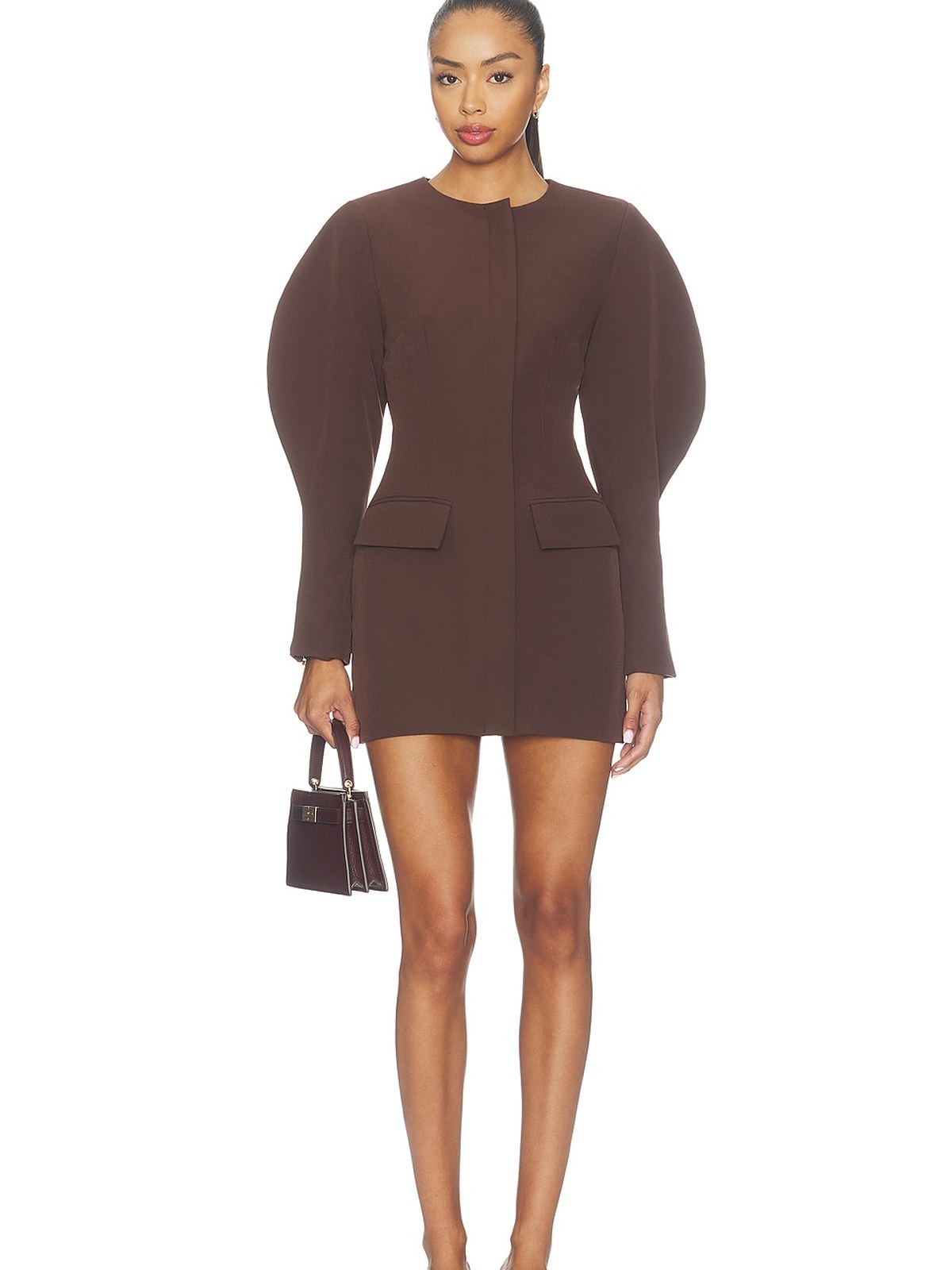Model in a dark brown sculpted puff sleeve mini dress carrying a small bag