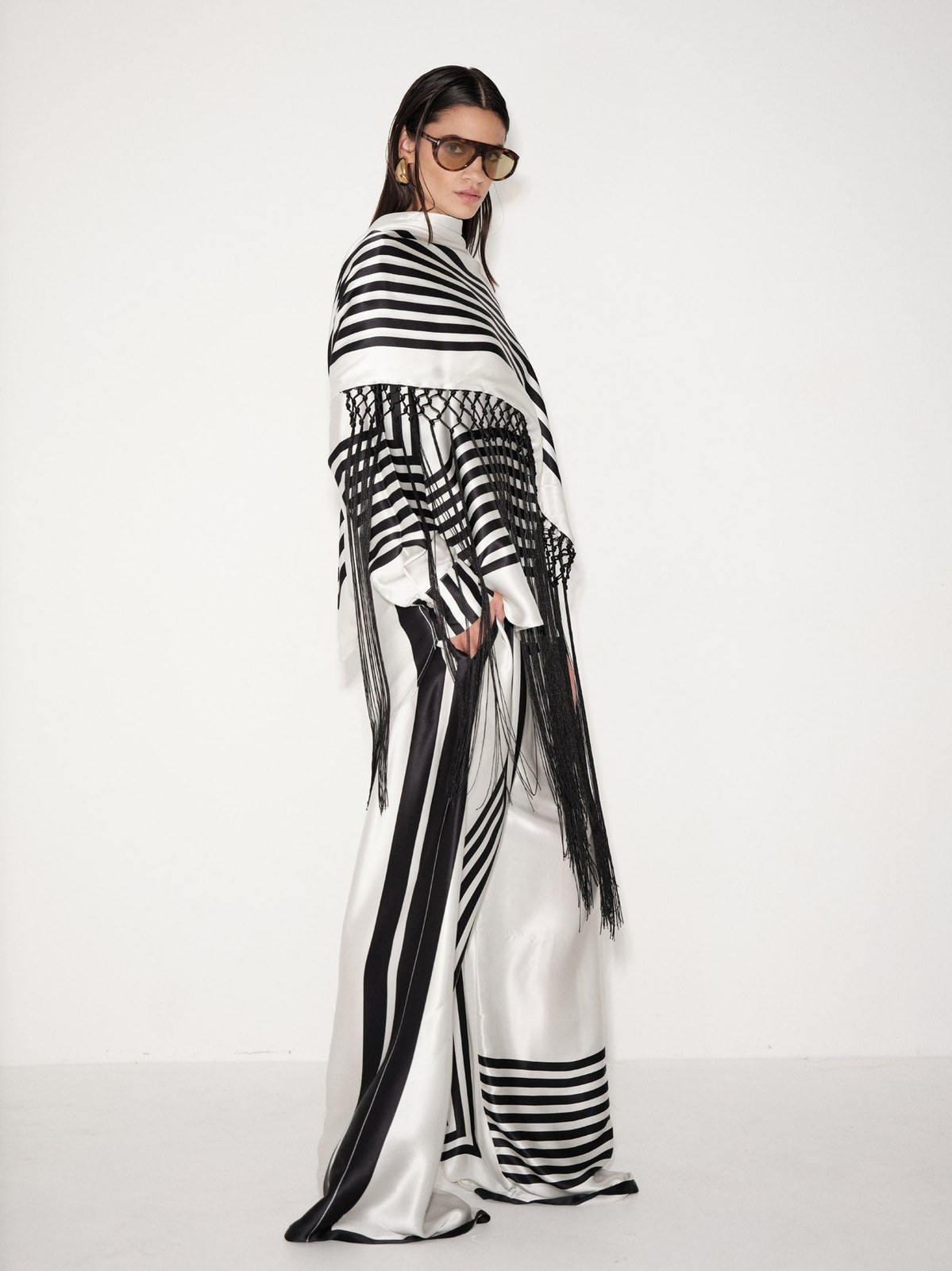 Model wearing a black and white striped Delfi look in a campaign studio