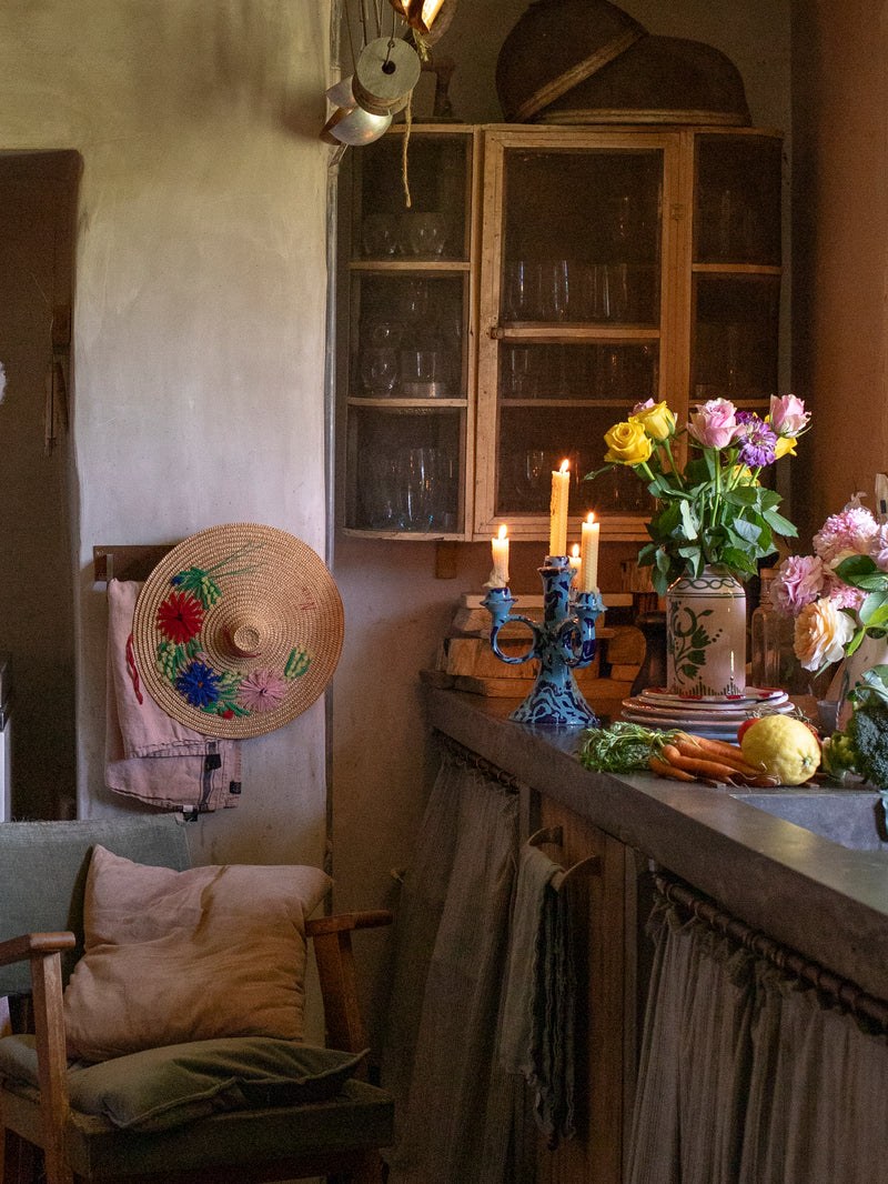 Vases, flowers and tableware in a rustic kitchen