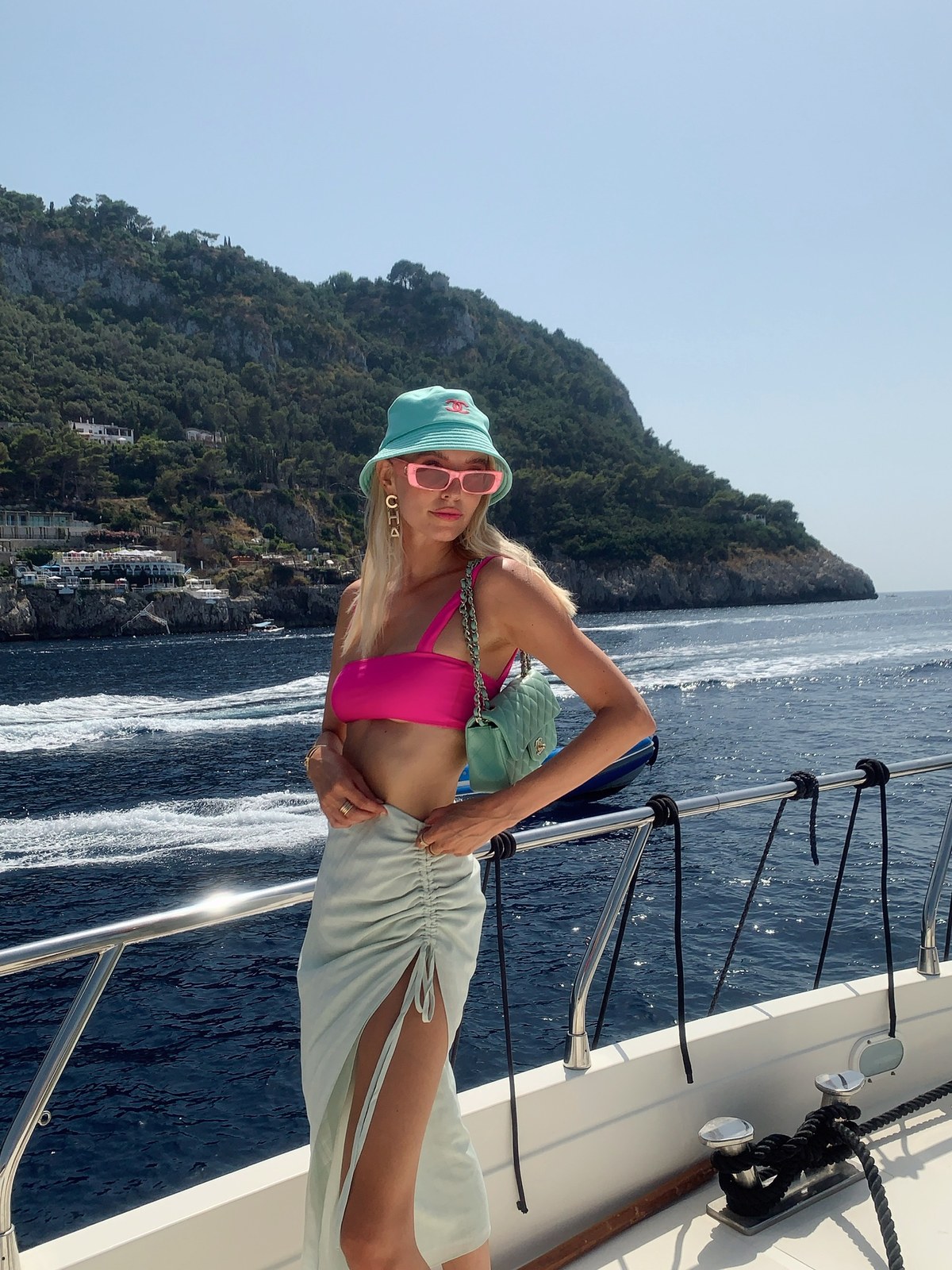 Leonie Hanne in a pink Lovewave bikini aboard a boat off the Amalfi Coast