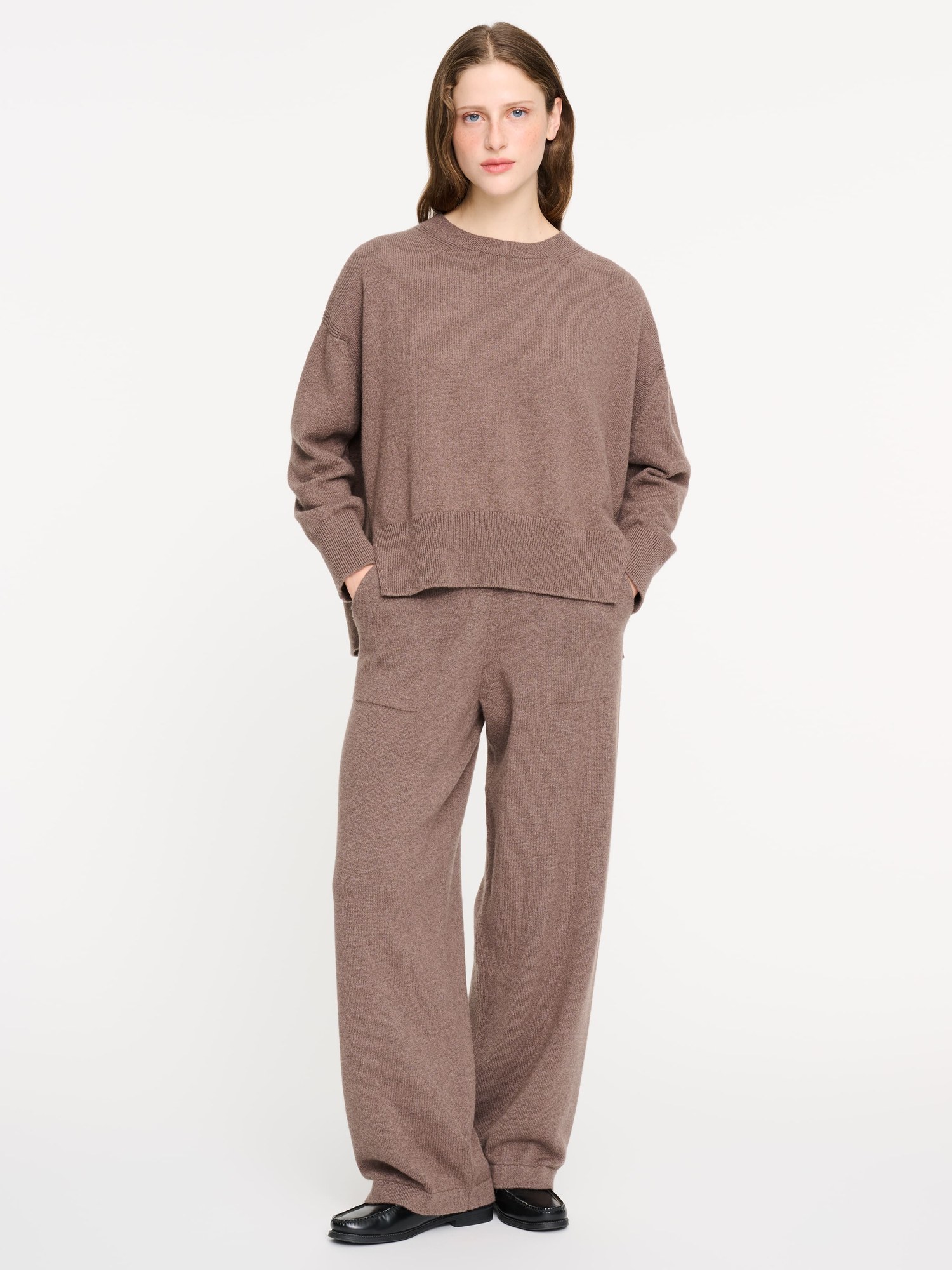 Model in a taupe oversized cashmere jumper and matching wide trousers