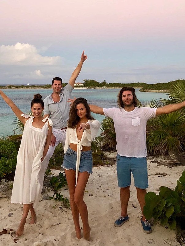 Four FUNBOY founders standing together at a beach