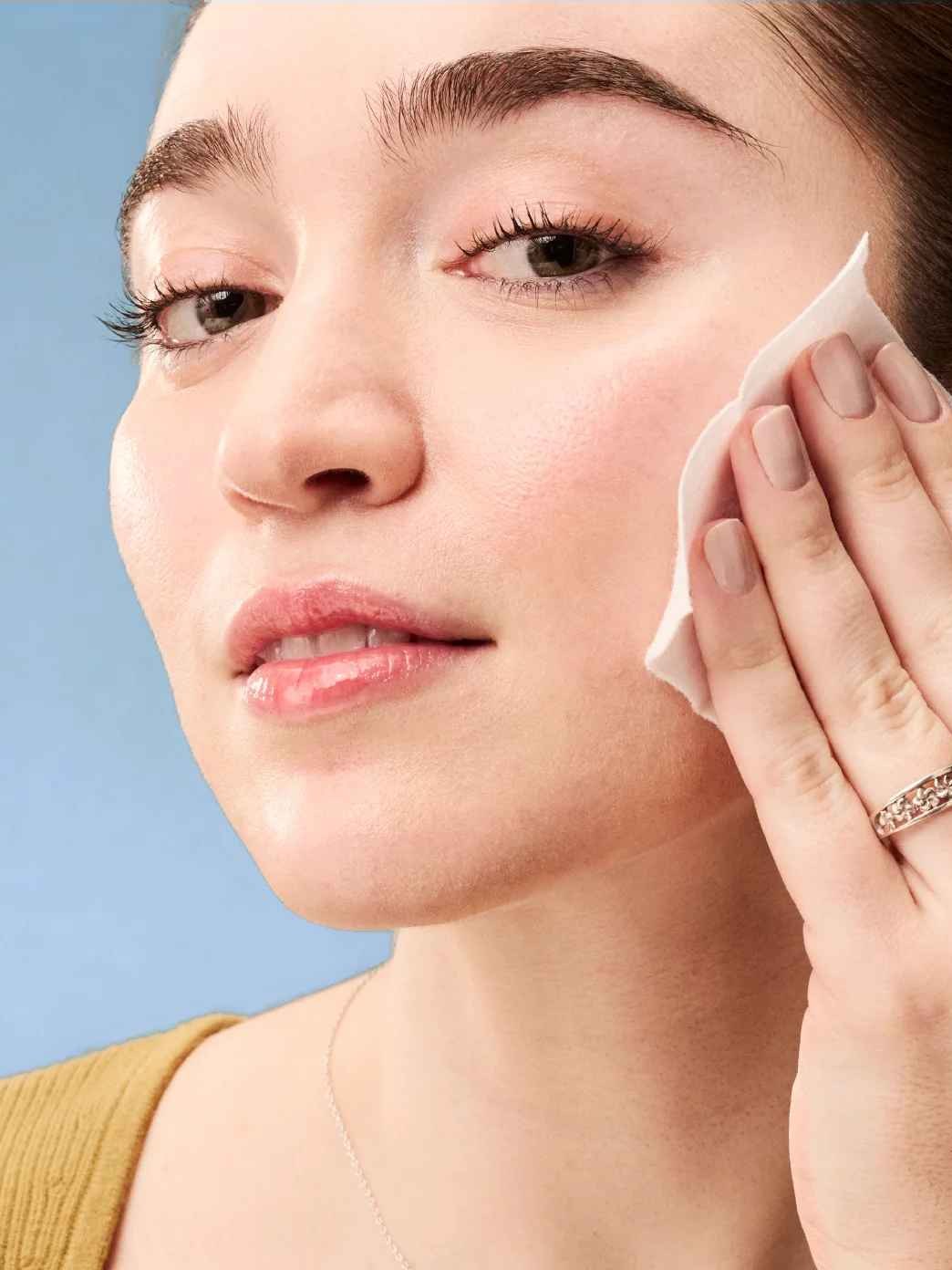 Woman applying a peel pad in a close beauty portrait