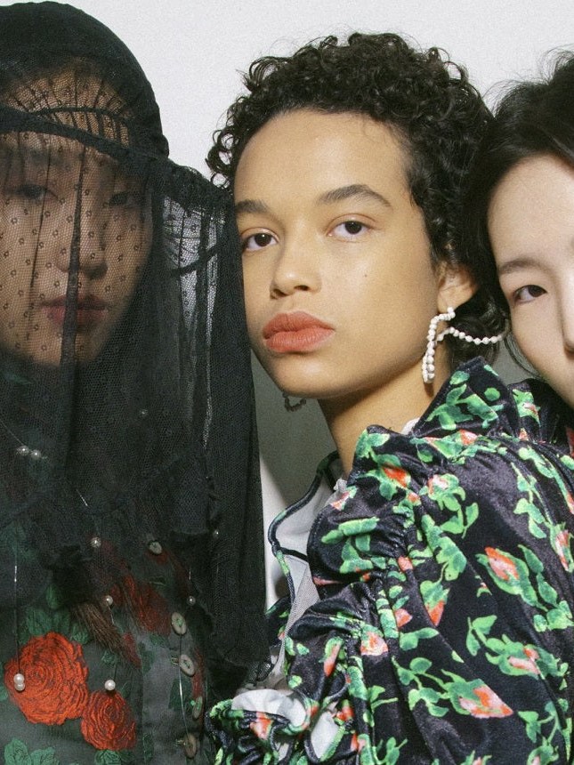 Models in dark floral and lace runway looks