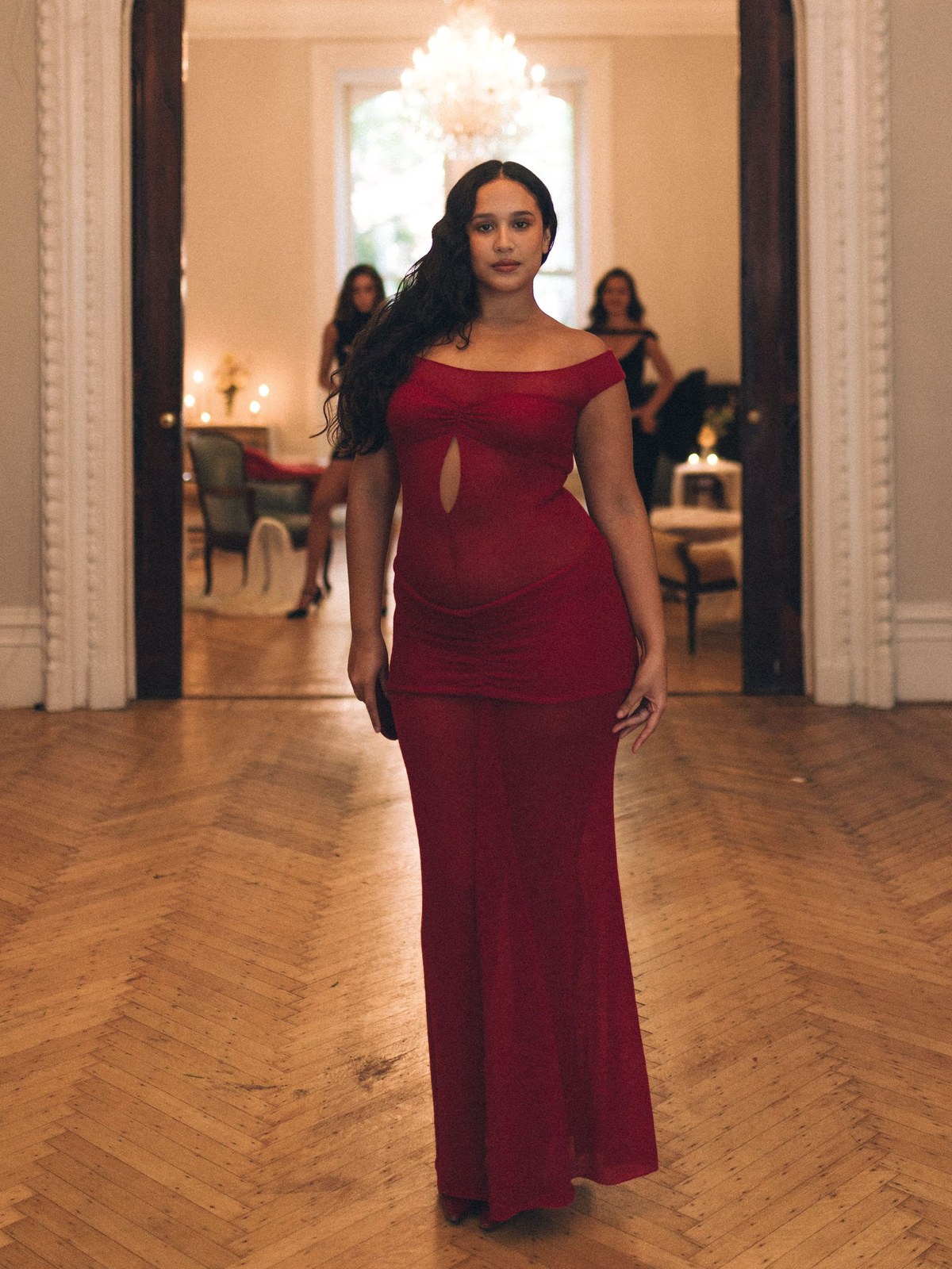 BUCI runway model in a fitted burgundy dress