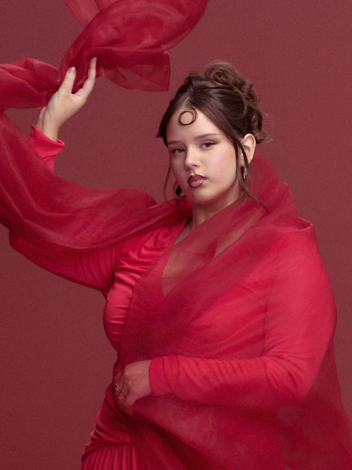 Paloma Sánchez in a red dress with translucent red fabric
