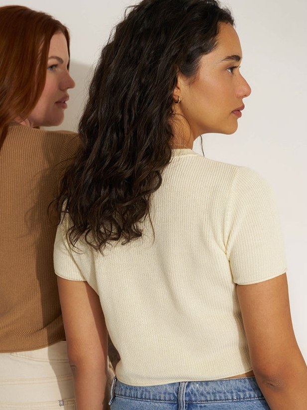Two women in Callahan knitwear in side profile against a pale backdrop