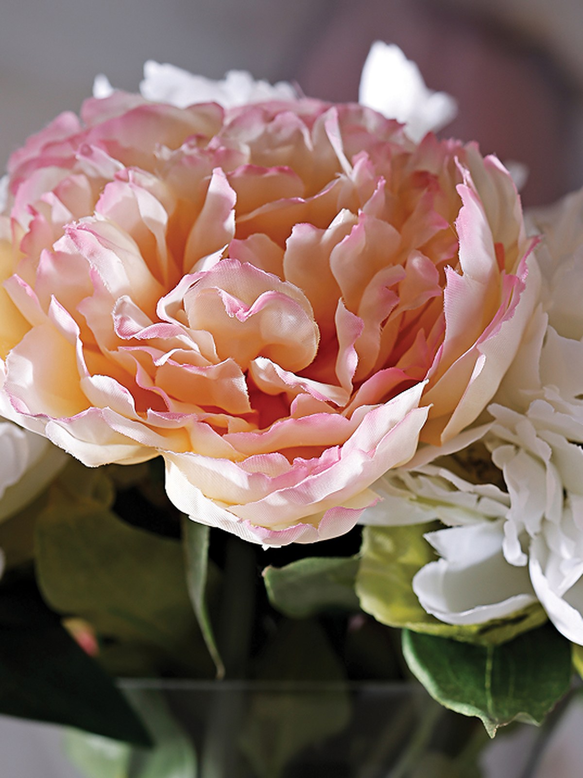Pink peony and white blooms in a vase