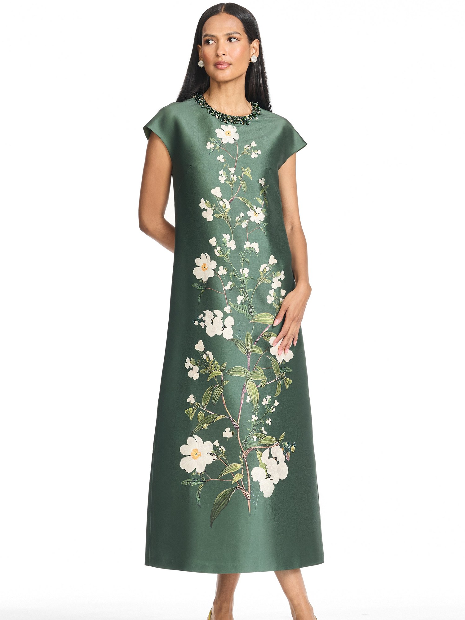 Model in a green floral mikado midi dress with a jeweled neckline and gold heels