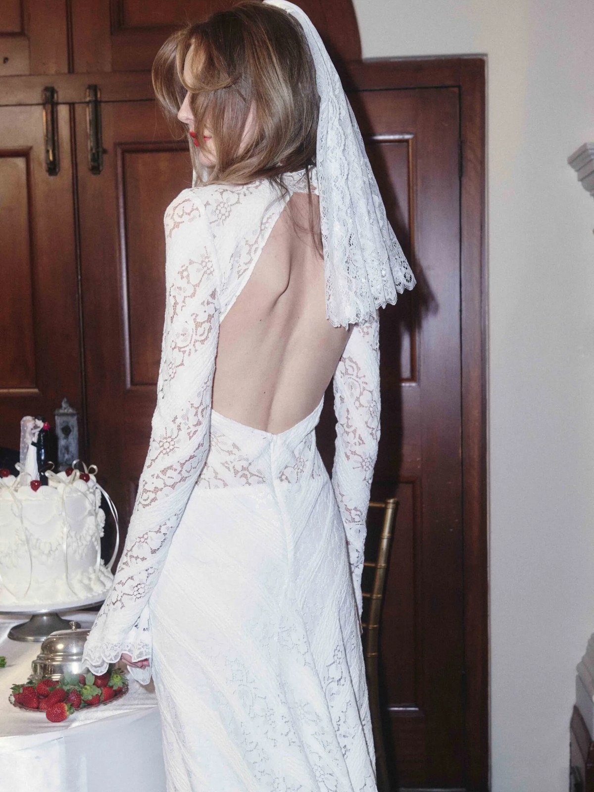 Model in a lace bridal look shown in profile