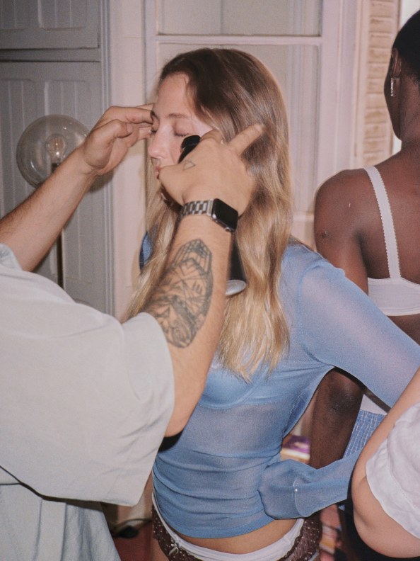 A model has her makeup done backstage for the Sage’s Rose campaign
