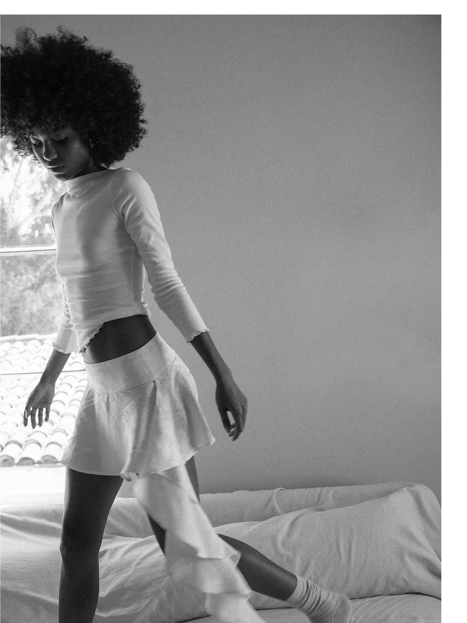 Black and white lookbook portrait of a model by a window