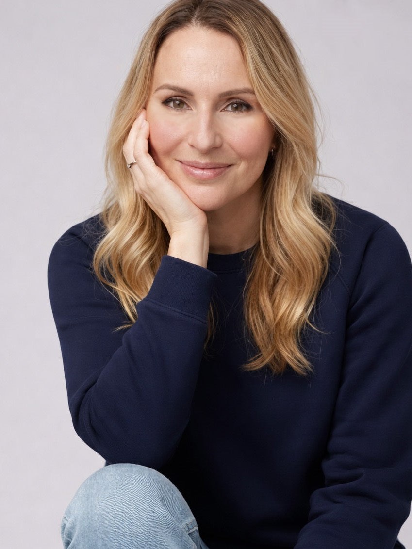 Solaris founder Iliana Ivanova in a navy sweater, seated against a pale studio background