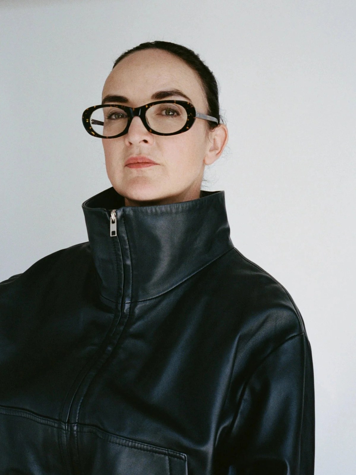 Founder Frances Shoemack in a black leather coat against a pale background